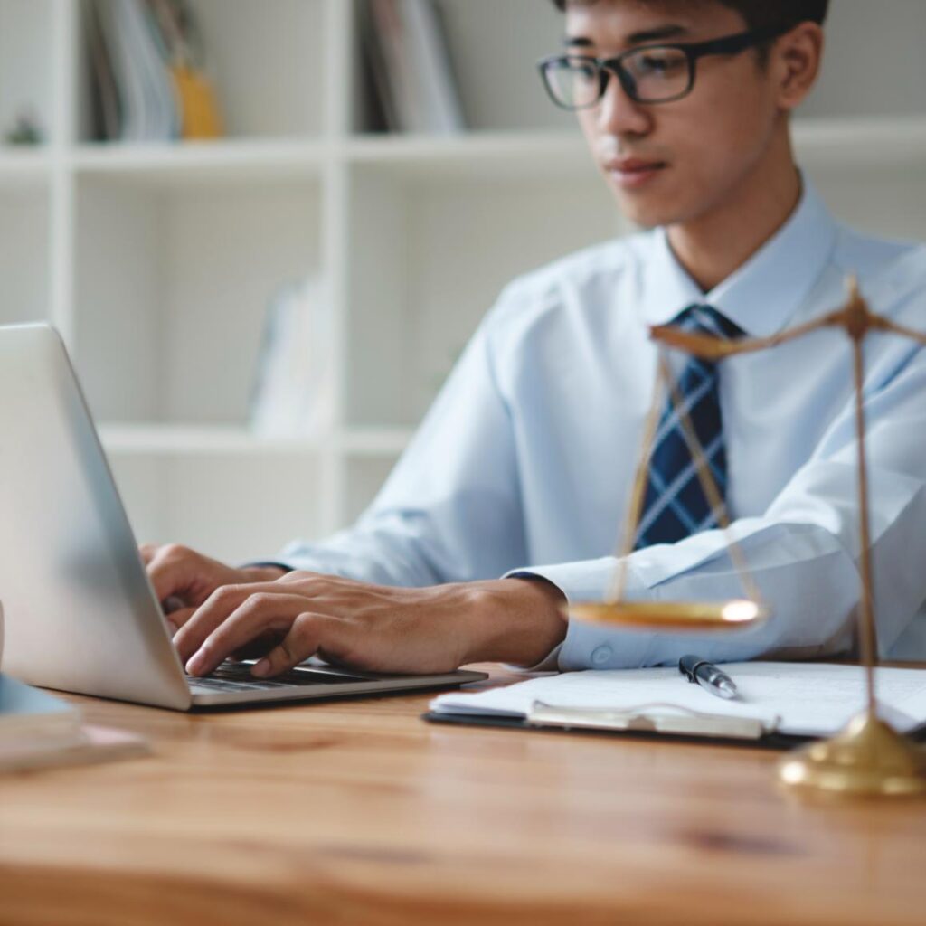 Lawyer Working On Laptop With Scales Of Justice In Q2QZ8CS 1 1024x1024